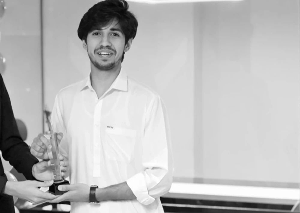 Umer Mehmood receiving a Best Performer award